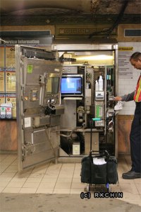 A Metrocard mechanic cleaning some parts of the machine.